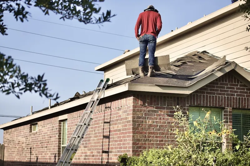 Professional roofer working on a residential roof in Villa Marie Claire